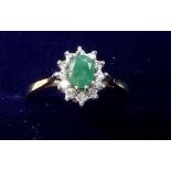 A 9 carat gold emerald and diamond ring - size L/M