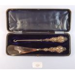 A silver shoe horn and button hook - cased