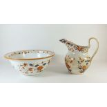 An early 19th century Wedgwood cream ware toiletry jug and bowl set with iron red and blue floral