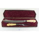 A Victorian carving set with ivory handles carved with the head of John Wesley - in fitted case