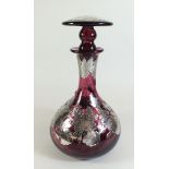 A pink glass decanter and stopper with silver floral overlay