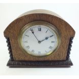 An Edwardian French eight day mantel clock in an oak case