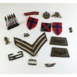 A small selection of WWII period cloth badges, insignia and cap badges