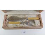 A pair of silver plated fish servers with ivory handles and silver collars - hallmarked Sheffield