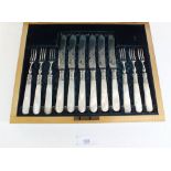 A late 19th/early 20th century set of six fruit knives and forks with mother of pearl handles and