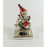 A white metal clown figure