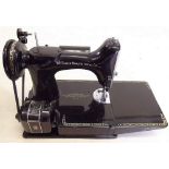 A Singer sewing machine 221K in case and with accessories and book