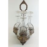 A Victorian silver plated triple decanter stand with three original cut glass decanter