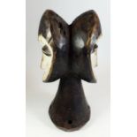 A Janus headed African carved wood tribal headdress - 26cm tall