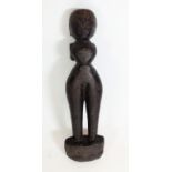 An Indian carved wood tribal figurine - 29cm tall