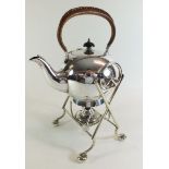 A silver plated spirit kettle on a stand