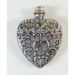 A silver heart form pendant perfume bottle with embossed decoration