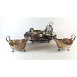 A group of silver plated items including two sauce boats, a serving dish, a toast rack and a