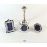 A small silver photographs frame, two miniature silver circular frames and a waisted silver