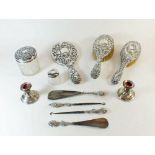 A silver backed group of two dressing table brushes, mirror, two button hooks, two shoe horns, two