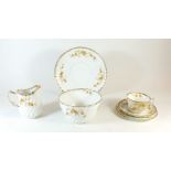 An Edwardian gilt and floral tea service comprising six cups and eleven saucers, nine tea plates,