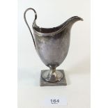 A George III silver helmet form cream jug, repaired London 1791