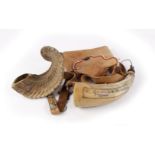 Horn powder flask with scrimshaw decoration, leather pouch the strap with pewter trade badges, and a