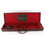 Leather gun case with red baize lined fitted interior for 28 ins barrels (will take 30 ins), mounted