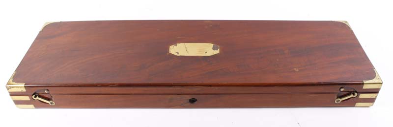 Mahogany gun case with brass name plate and corners, green baize lined fitted interior for