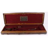 Oak and leather gun case with brass corners, claret baize lined fitted interior for 30 ins