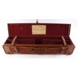 Lightweight tan leather double gun case with red baize lined interior for 28 ins barrels, mounted