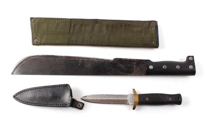 Modern machete with 13 ins steel blade, metal studded black plastic grips in canvas sheath; Japanese