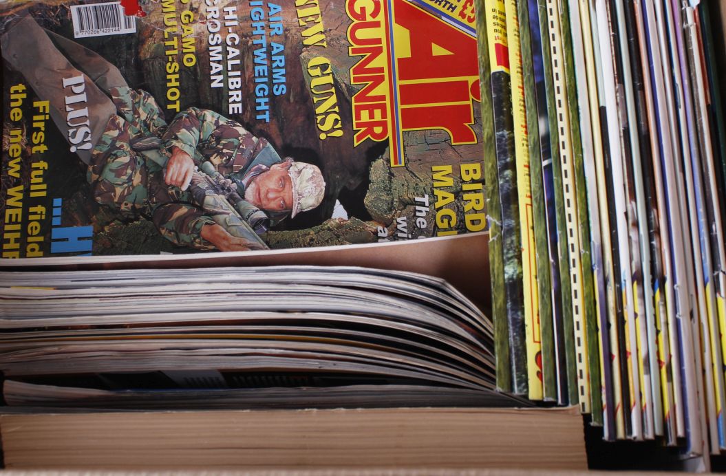 Box containing various shooting books and magazines