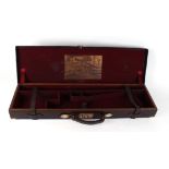 Oak and leather motor case with brass corners, red baize fitted interior for 30½ ins barrels,