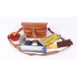 Tan leather cartridge bag containing various cleaning tools