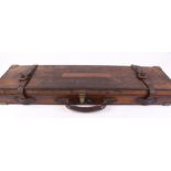 Brown leather gun case, brass corners, blue baize lined interior fitted for up to 30 ins barrels,