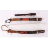 Two police style wooden truncheons together with two black painted decorative wooden truncheons, one