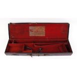 Leather gun case with brass corners, red baize lined fitted interior for 30 ins barrels with Russell