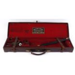 Leather gun case with brass corners, red baize lined fitted interior fo 30 ins barrels, William
