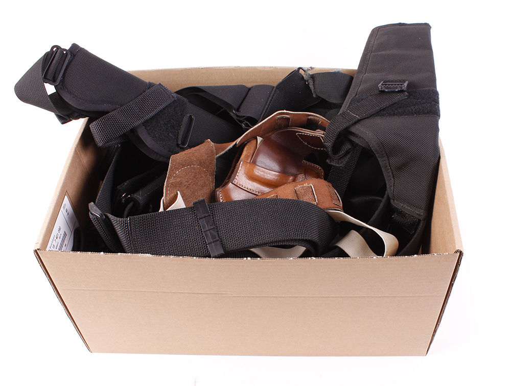 Box containing Gunslinger canvas belts, shoulder holster, Bianchi sheath etc.