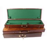 Three wooden gun cases with green baize lined interiors, with keys