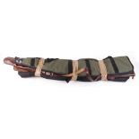 Four various gun slips and leather cartridge belt