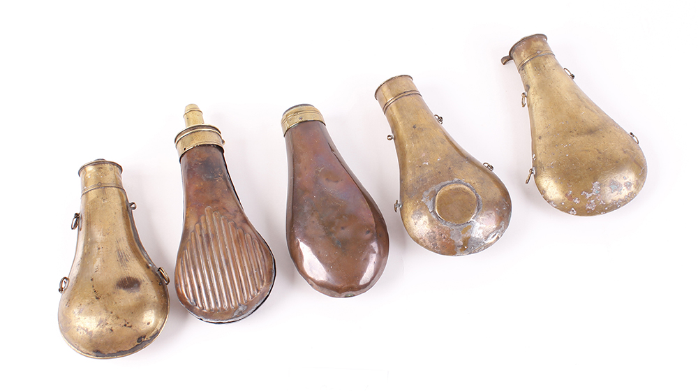 Five assorted copper and brass powder flasks