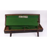 Oak and leather gun case with green baize lined interior for 32 ins barrels, brass corners, brass