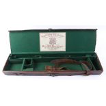 Red leather gun case, handle to hinge side, Holland & Holland trade label, green baize lined