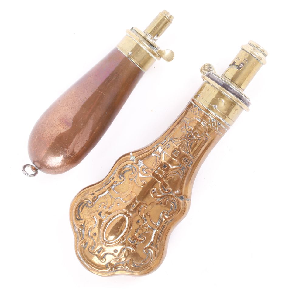 Copper and brass relief decorated powder flask by Hawksley, of escutcheon form,