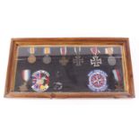 Four German and four British WWI and WWII medals mounted in display case