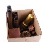 Box of militaria including two 2½ ins diameter brass shell cases,