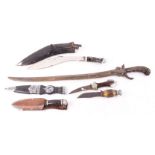 Six knives to include: Indian Kukri in scabbard; Hubertus knife; oriental short sabre;