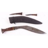 Kukri knife, 11 ins blade, brass mounted wood grips in leather covered scabbard,