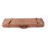 Leather gun case with brass corners, claret baize lined fitted interior for 30 ins barrels, H.