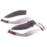 Two Kukri knives, 13 ins and 12½ ins blades, each with wood grips, in covered wooden sheath,