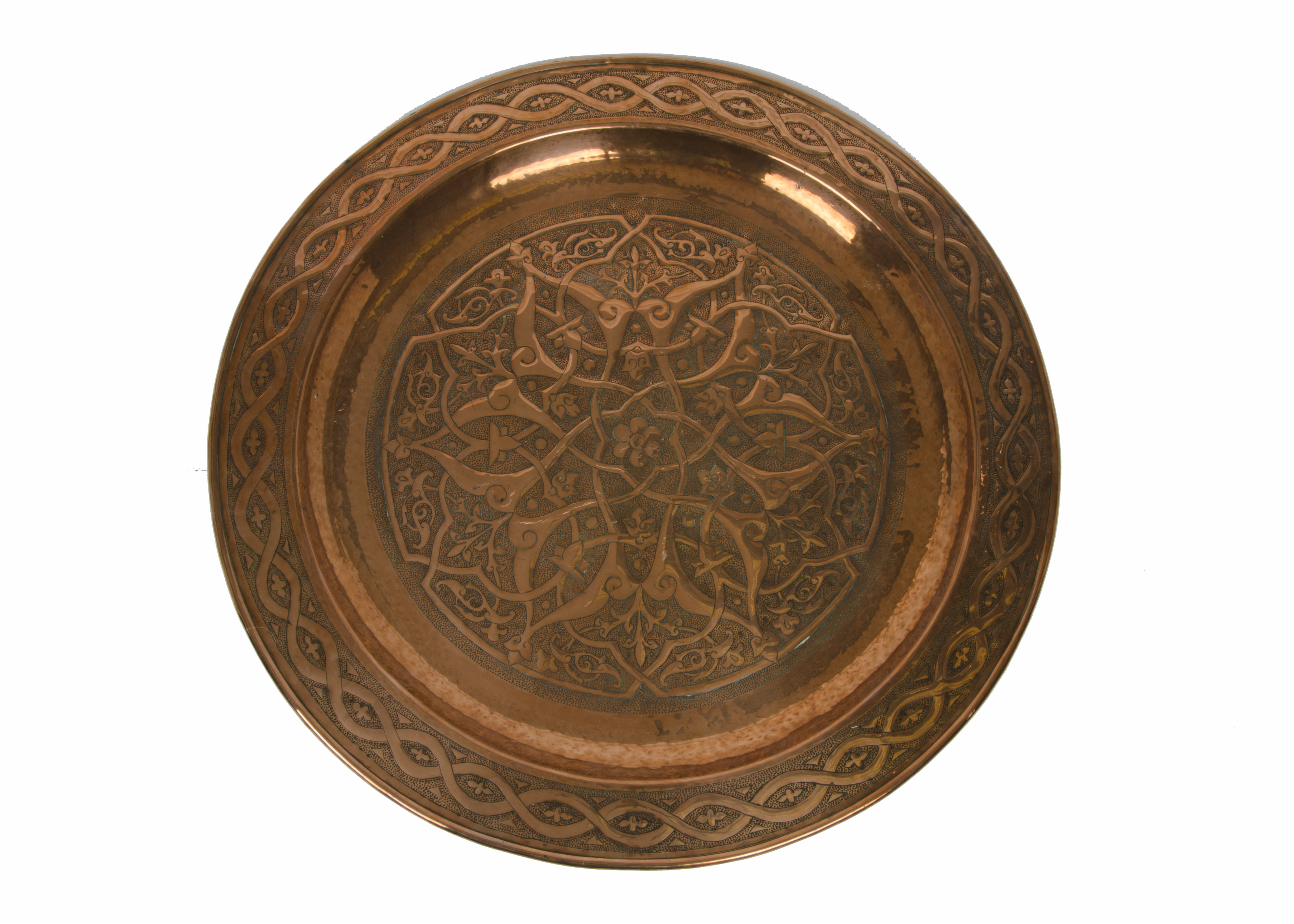 A collection of copperware, including a large circular dish, punched foliate and twist decoration,