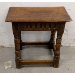 An 18th Century carved oak joint stool, turned supports united by stretchers, 44 cm high