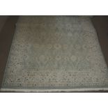 A modern woollen Turkish rug, cream scroll decoration on blue ground, cream border, 200 cm x 300 cm